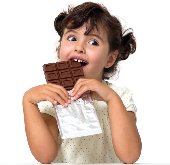 little girl eating chocolate isolated on white